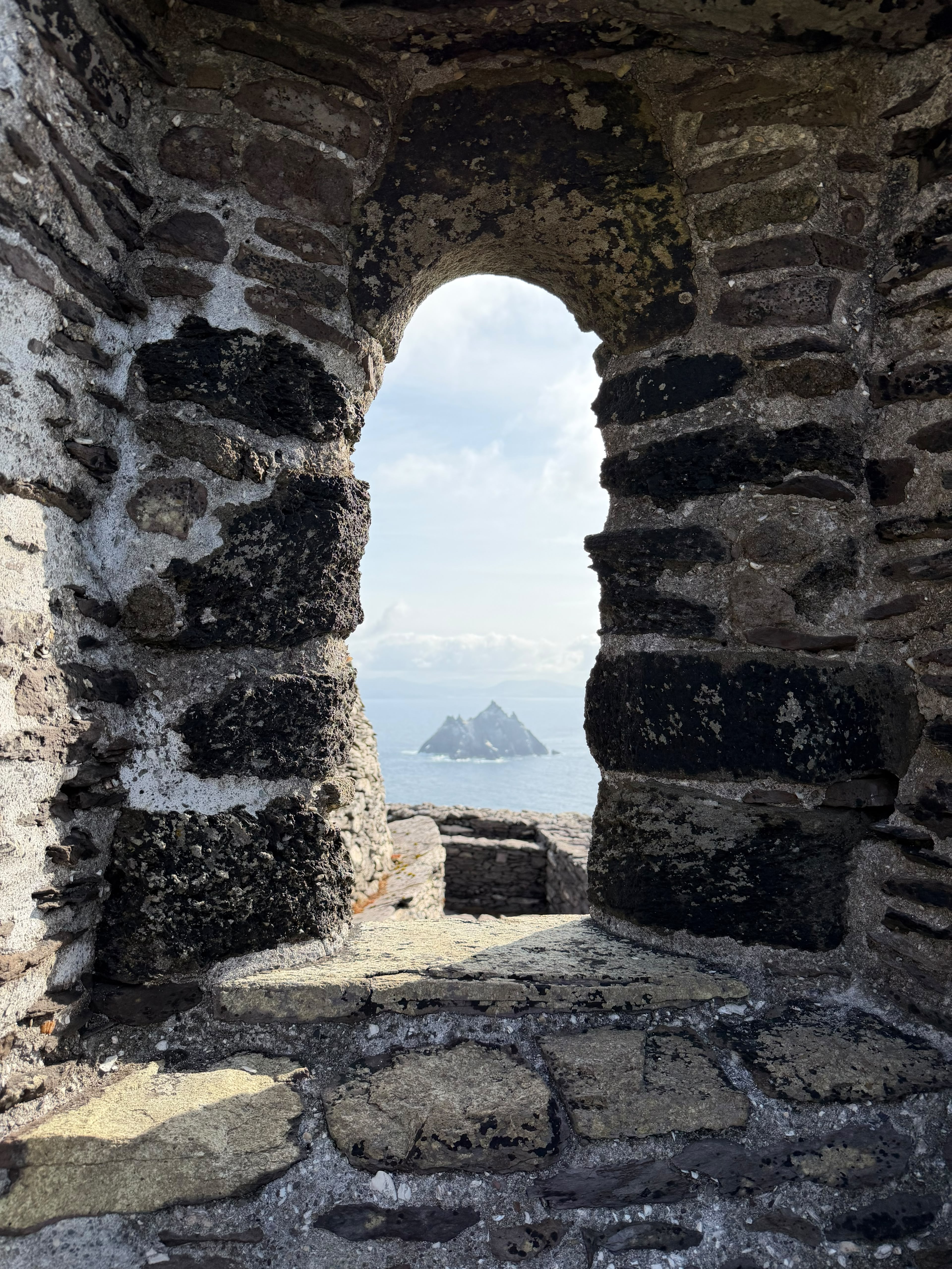Little Skellig framed by a stone window in the monastery